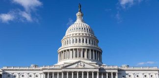 U.S. Capitol building under a clear blue sky.