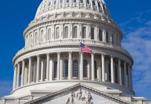 U.S. Capitol dome with American flag flying.