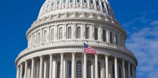 U.S. Capitol dome with American flag flying.