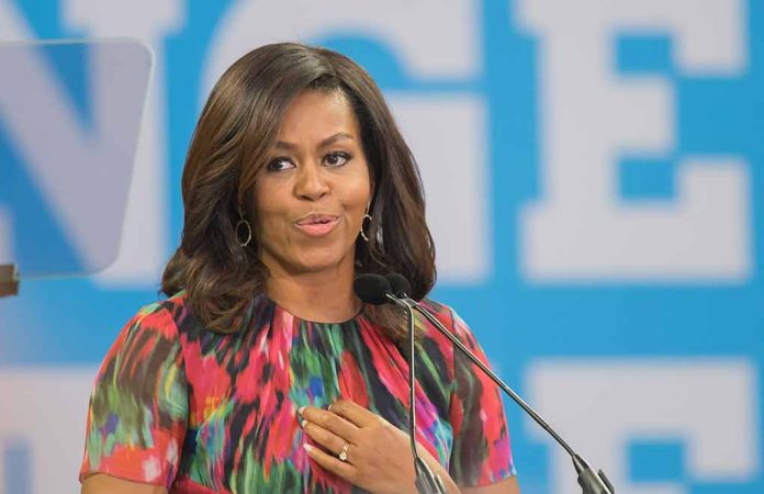 Woman speaking at podium with blue background.