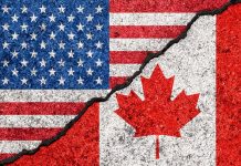 USA and Canada flag divided by crack