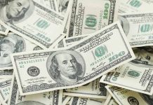 Pile of US one hundred dollar bills