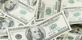 Pile of US one hundred dollar bills