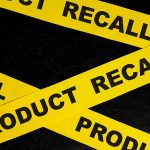 Yellow tape with product recall text crossing