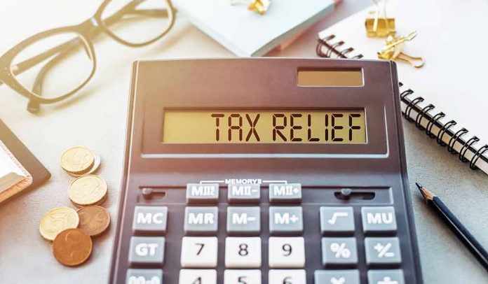 1908079453 featured image Calculator display reads TAX RELIEF amidst coins and glasses