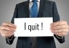 Person holding a sign saying I quit!