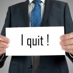 Person holding a sign saying I quit!