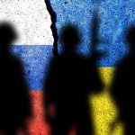 Silhouettes in front of Russian and Ukrainian flags