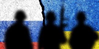 Silhouettes in front of Russian and Ukrainian flags
