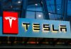 Tesla logo on a building at night