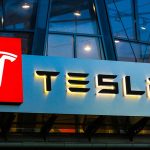 Tesla logo on a building at night