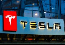 Tesla logo on a building at night