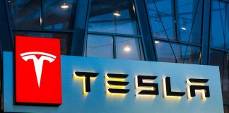 Tesla logo on a building at night