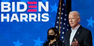 Two people speaking at a Biden Harris event