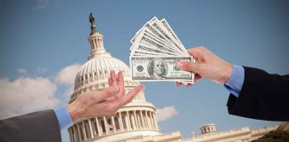 Hands exchanging money in front of Capitol building