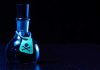Dark bottle with skull and crossbones label on table