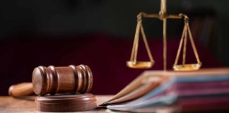 Judges gavel, scales of justice, and legal documents.