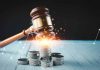 Gavel coins and tax icons on a table