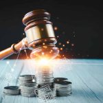 Gavel coins and tax icons on a table