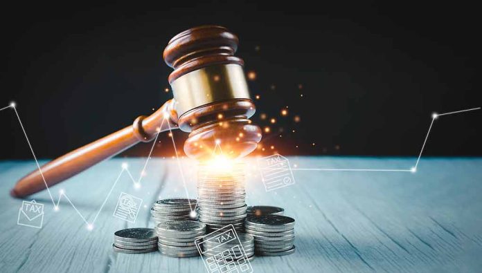Gavel coins and tax icons on a table