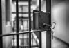 Jail cell door with key in lock