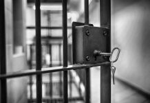 Jail cell door with key in lock