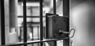 Jail cell door with key in lock