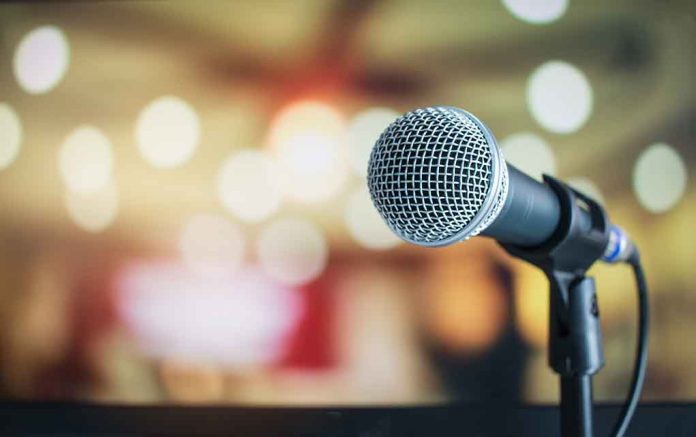 676019521 featured image Microphone with blurred lights in the background