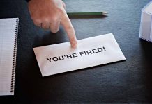 Envelope with YOU RE FIRED and pointing finger