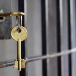 Key in lock of prison cell door