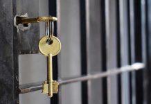 Key in lock of prison cell door