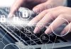 Hands typing with cybersecurity icons overlay.