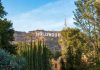 Hollywood sign on hill surrounded by trees and buildings