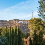 Hollywood sign on hill surrounded by trees and buildings