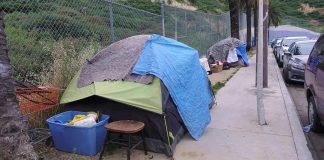 Tents and belongings set up along sidewalk