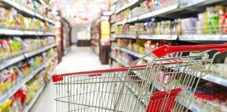 Empty shopping cart in grocery store aisle