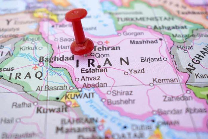 Red pushpin marking Iran on a map