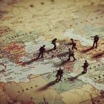 Toy soldiers on a world map background