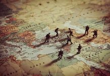Toy soldiers on a world map background