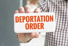 Hand holding sign with Deportation Order Text