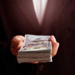 hand holding a stack of money