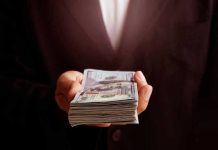hand holding a stack of money