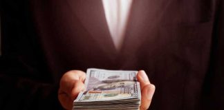 hand holding a stack of money