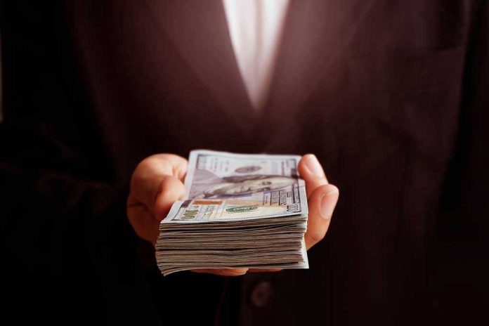 71912373 hand holding a stack of money