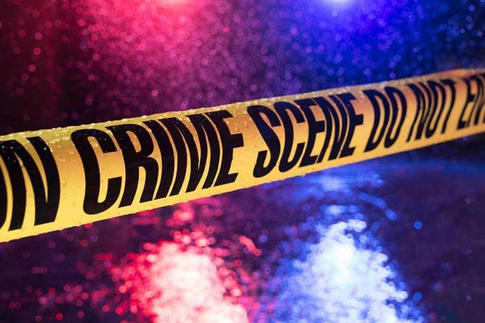 790342255 Yellow crime scene tape with police lights in background