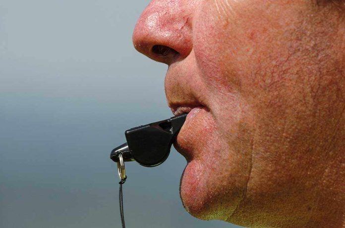 Close up of a sports coach blowing a whistle