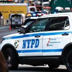 NYPD police car on a city street scene.
