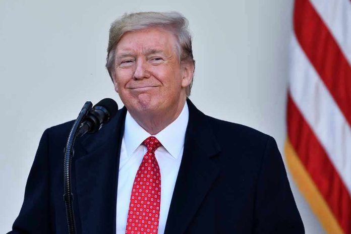1572261577 Man in suit and tie speaking at podium.