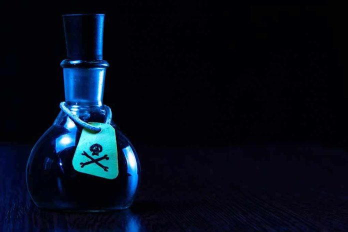 1946359798 Dark bottle with skull-and-crossbones label on table.