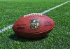 NFL football on a green field.
